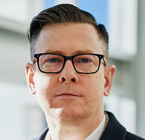 Portrait of CEO Alexander Hughes, executive at a crypto trading company